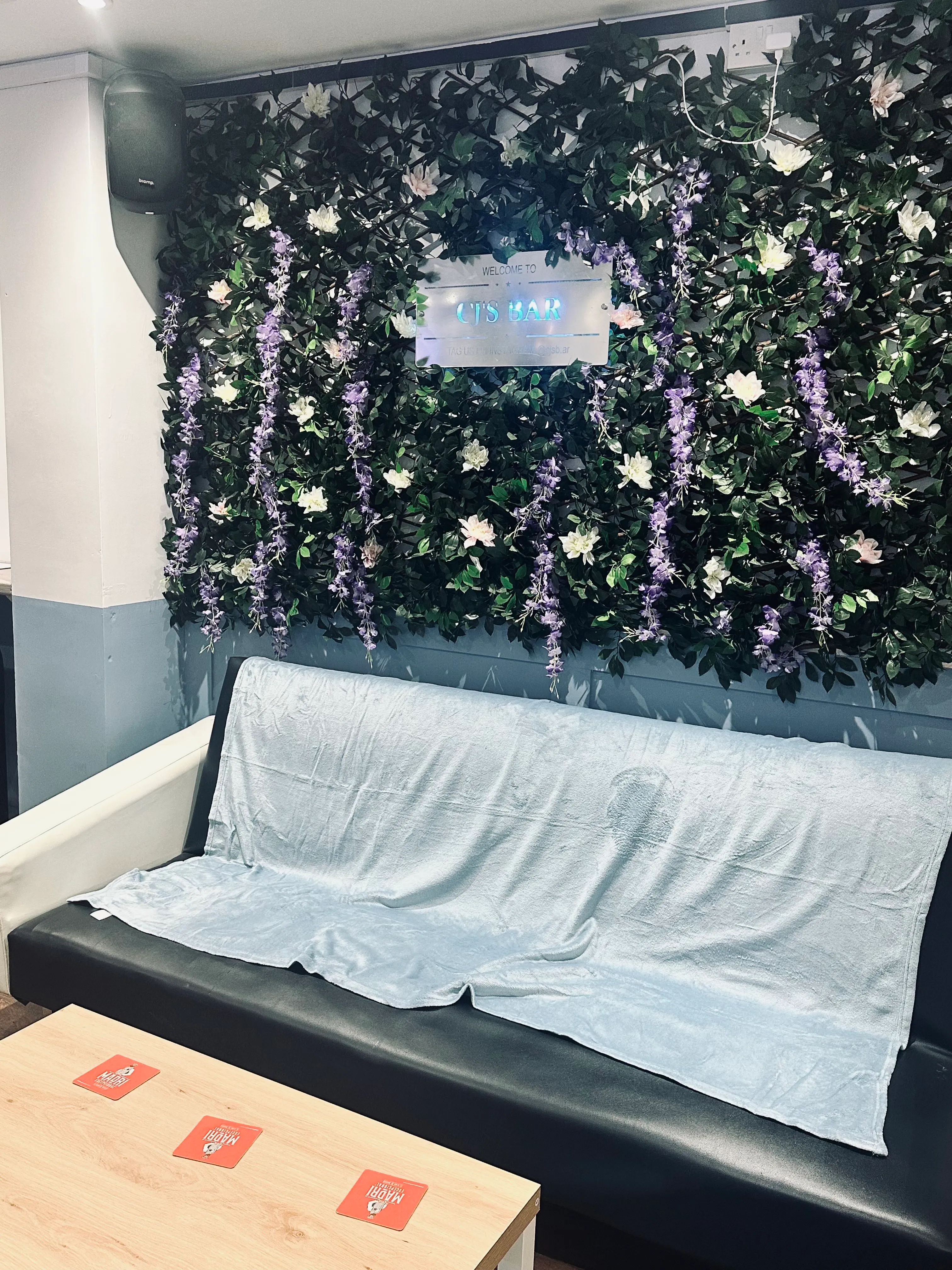 A couch sitting in front of a green wall.