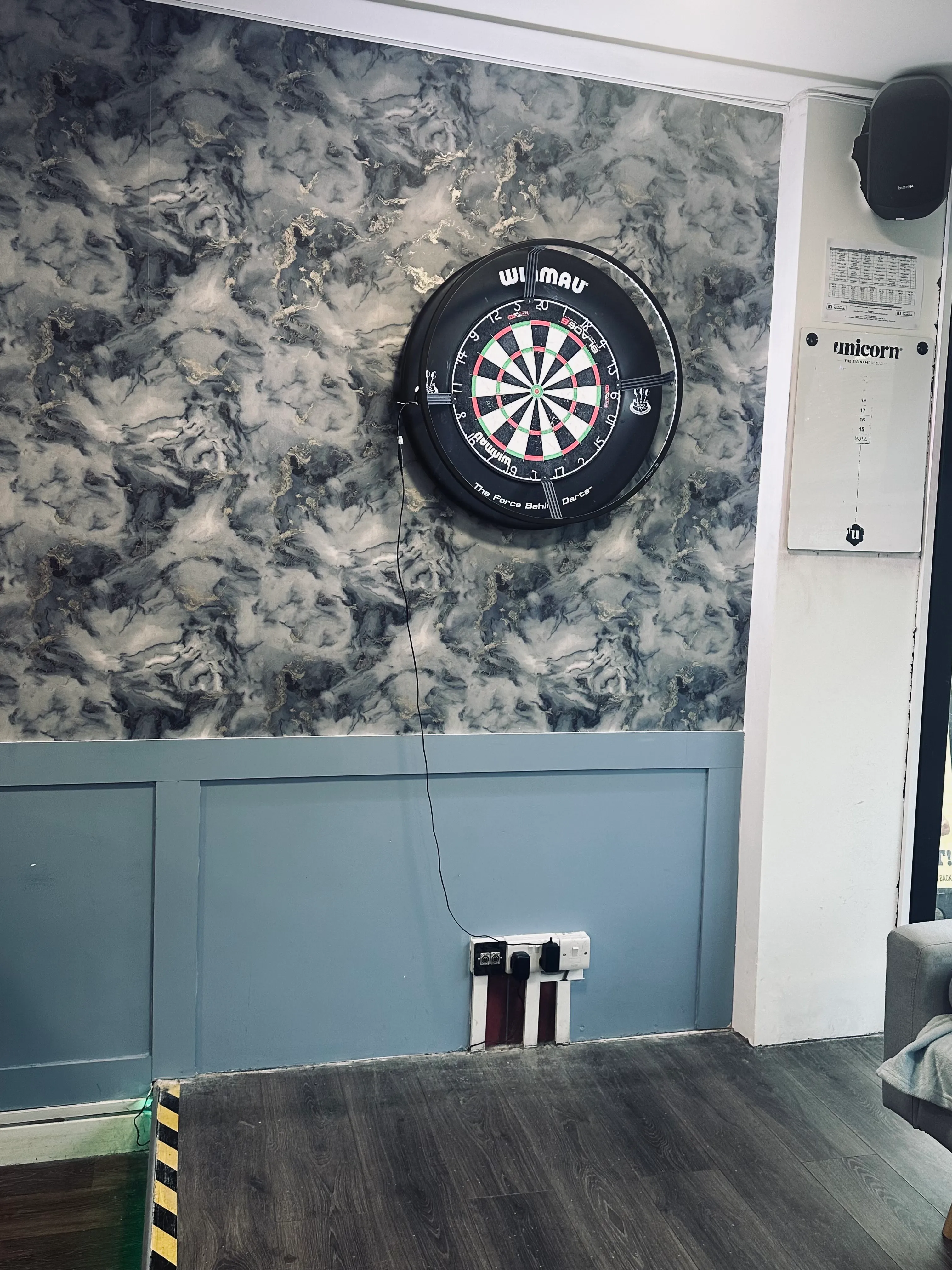 A dart on a wall with a dart in it.