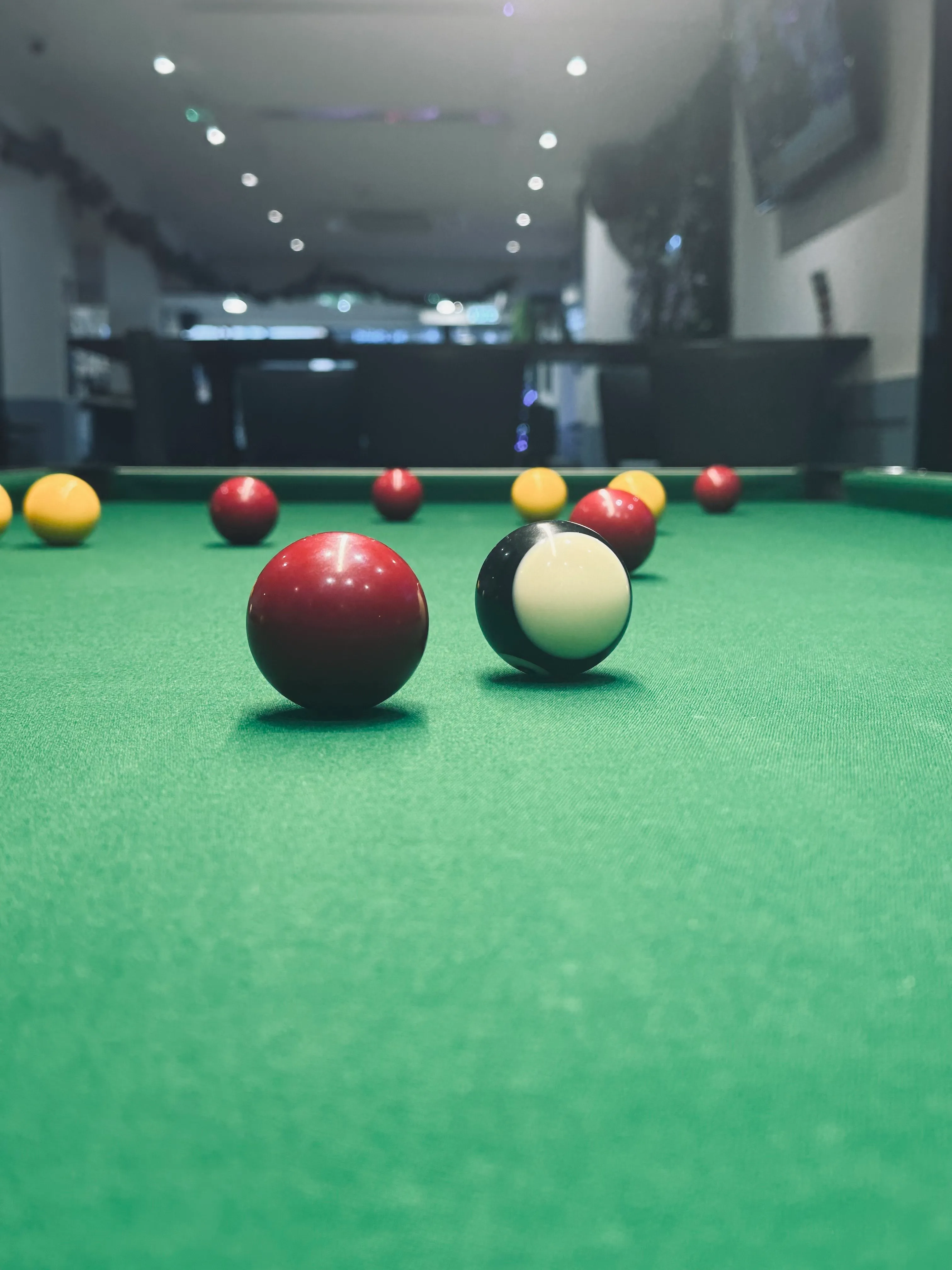 A pool table with several pool balls on it.